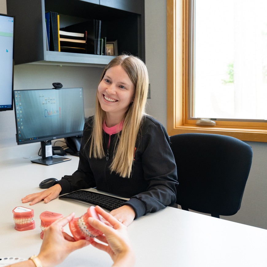 Ovation Orthodontics team member discussing adult treatment options with a patient