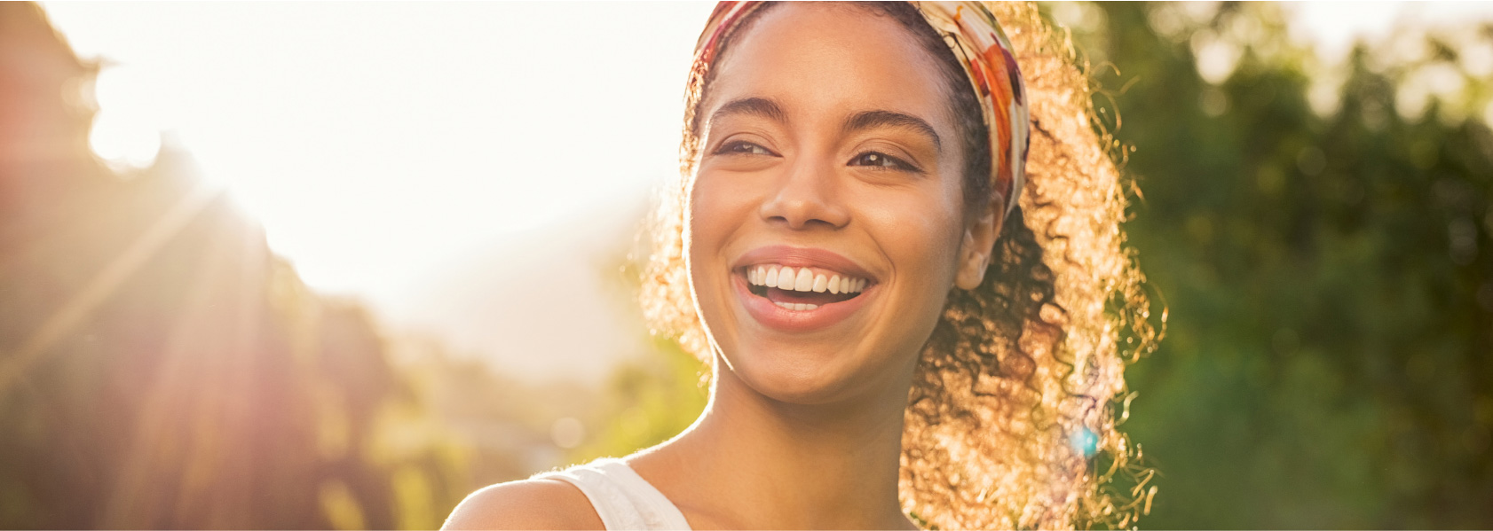 Oral Hygiene - African American girl smiling in front of the sun