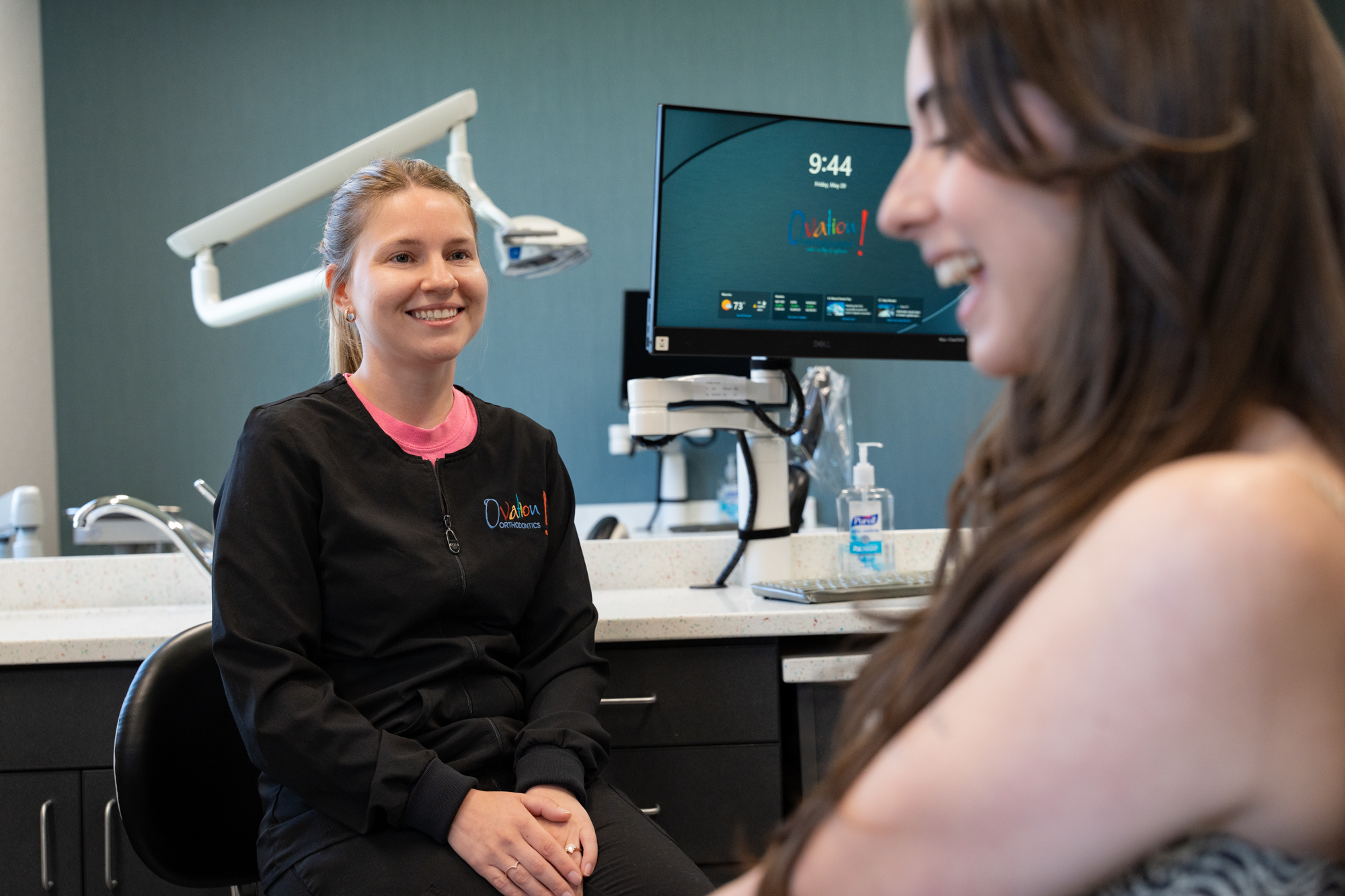 Orthodontic assistant reviewing digital scans with a patient at Ovation Orthodontics