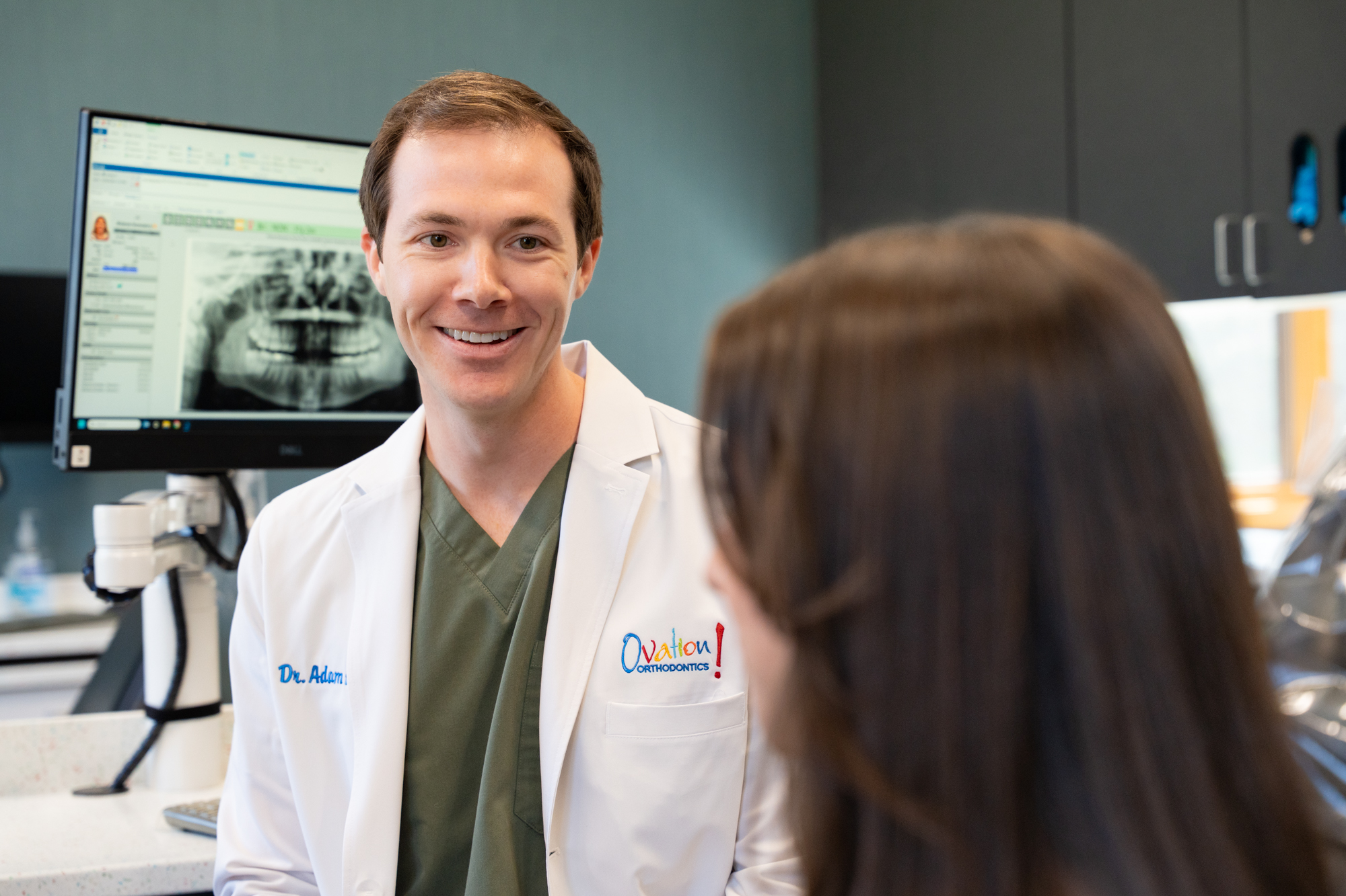 Orthodontist consulting with a patient at Ovation Orthodontics Dr. Adam Hoxie