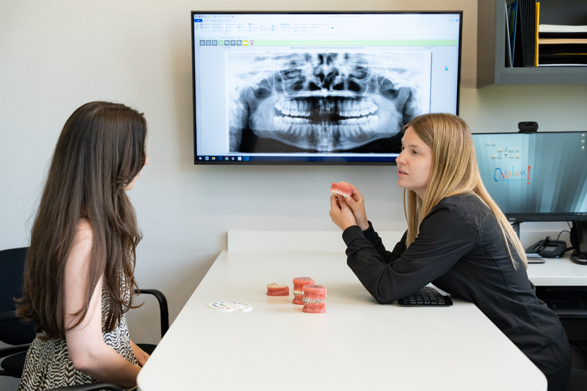 Reviewing a panoramic X-ray with a patient at Ovation Orthodontics