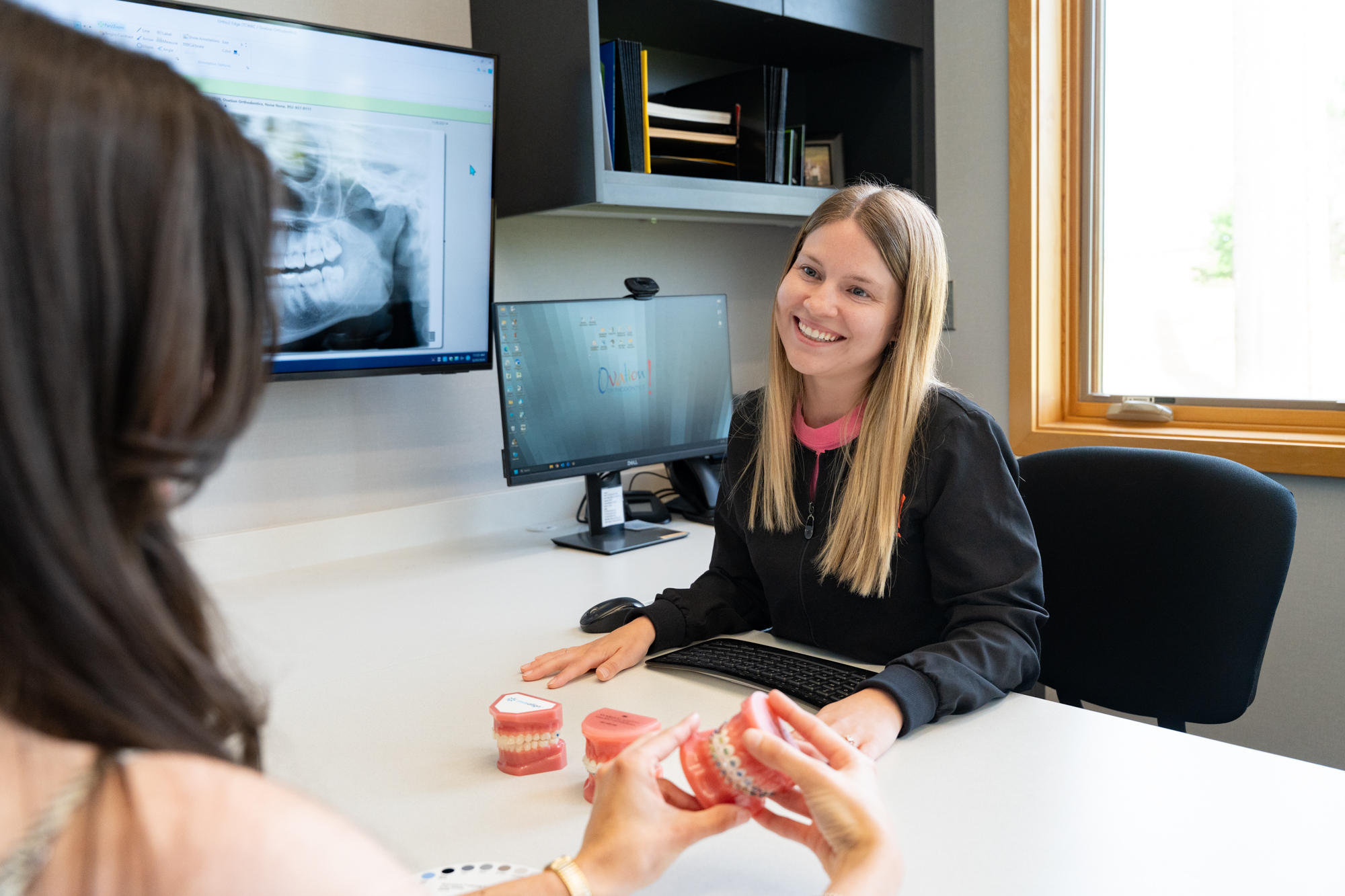 Orthodontic team member reviewing a patient X-ray at Ovation Orthodontics