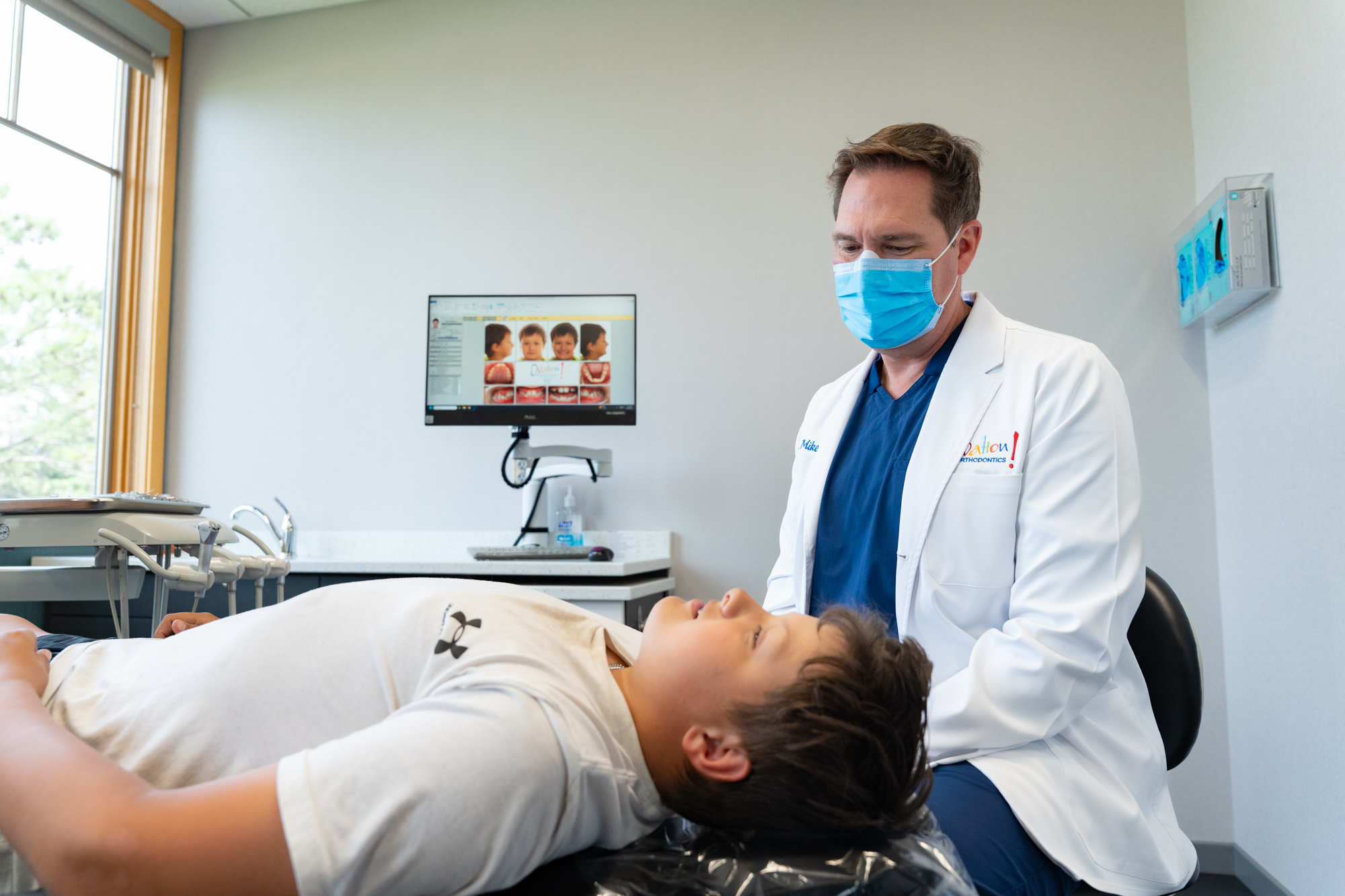 Orthodontist treating a young patient at Ovation Orthodontics
