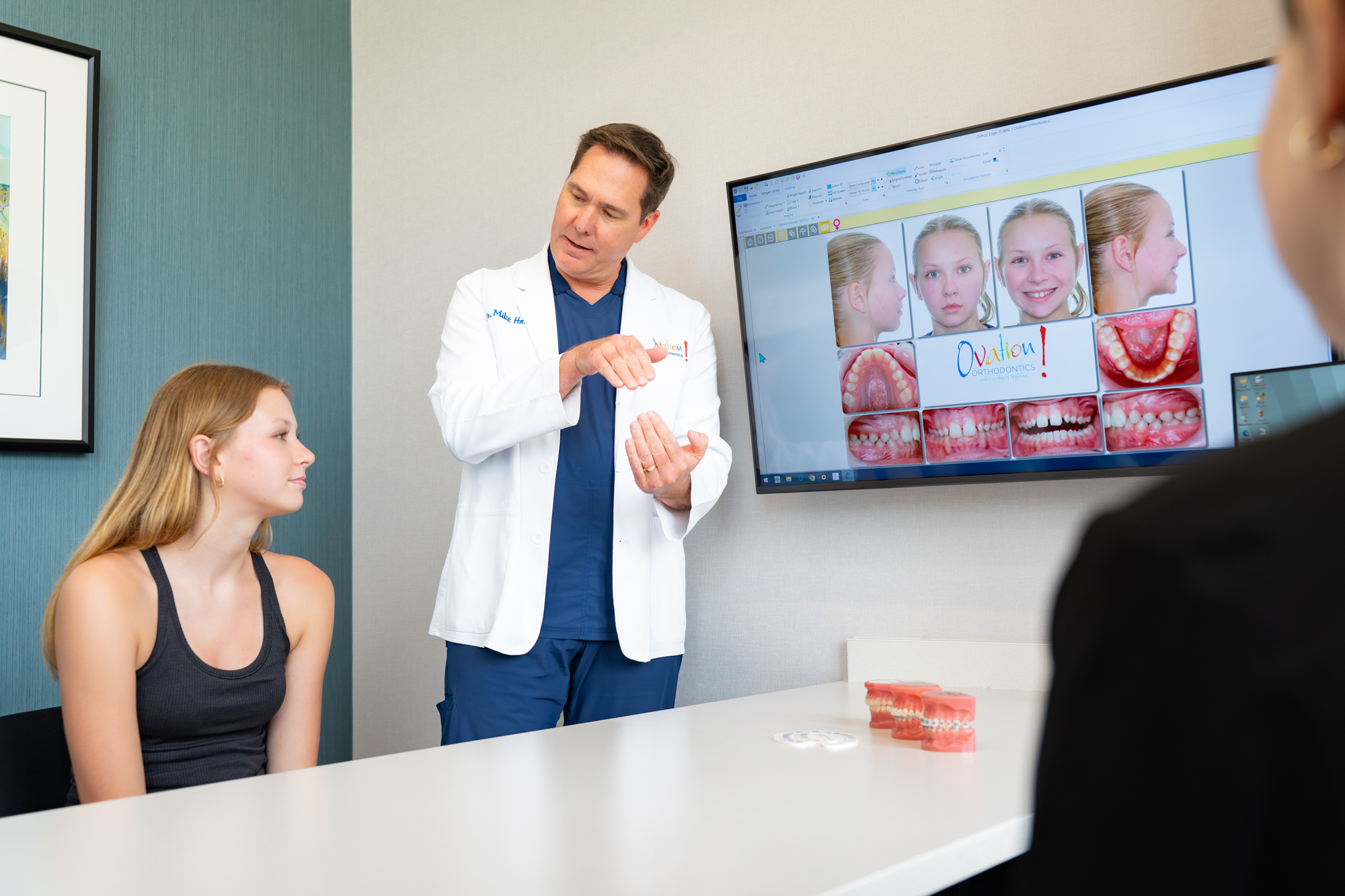 Orthodontist reviewing treatment options on screen at Ovation Orthodontics