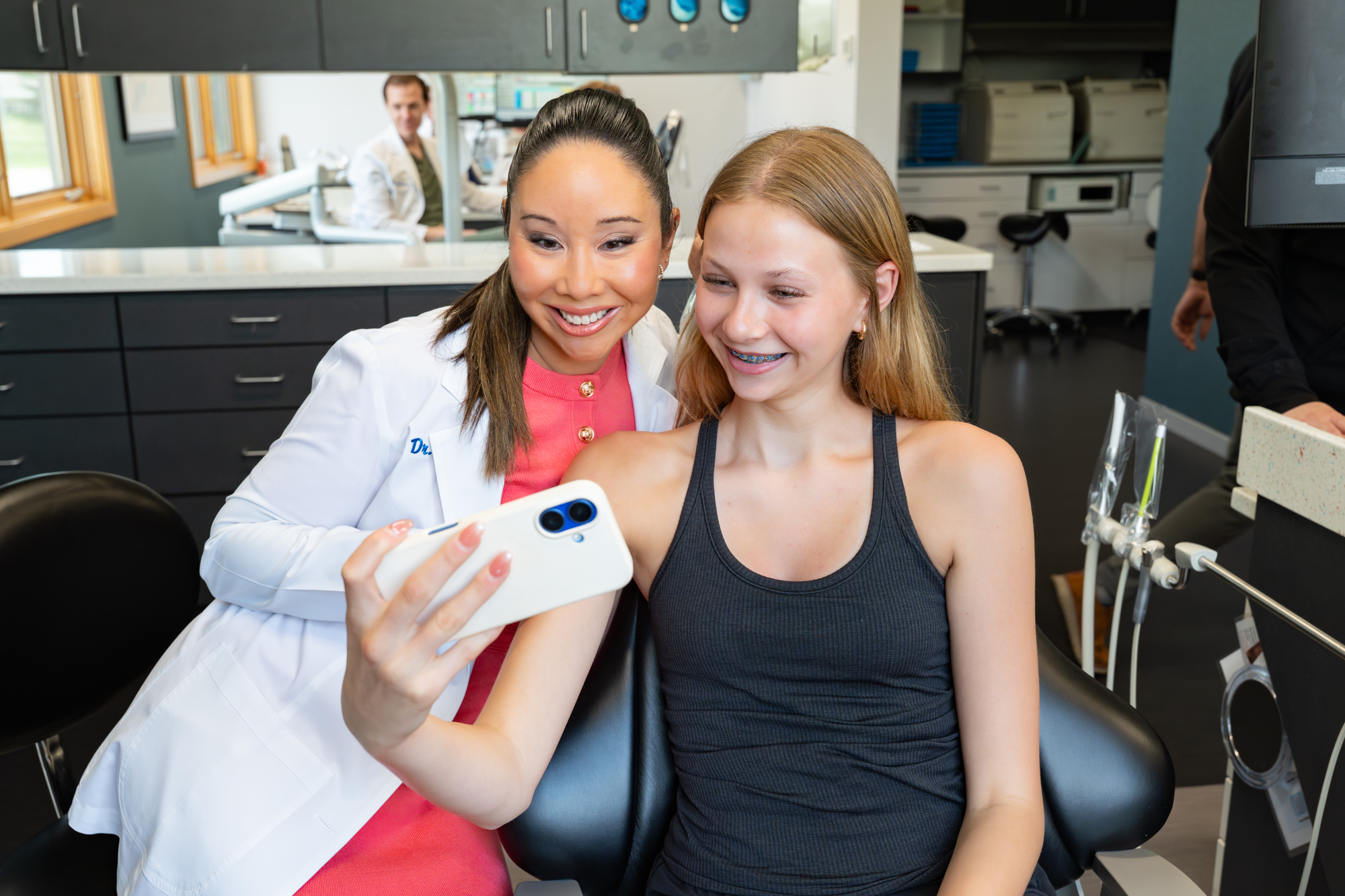 Dr. Tiffany Waki with a smiling teen patient at Ovation Orthodontics