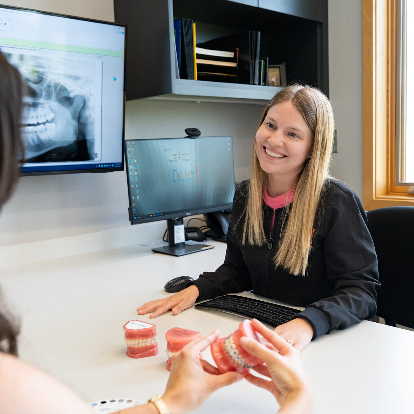 Orthodontic team member reviewing a patient X-ray at Ovation Orthodontics